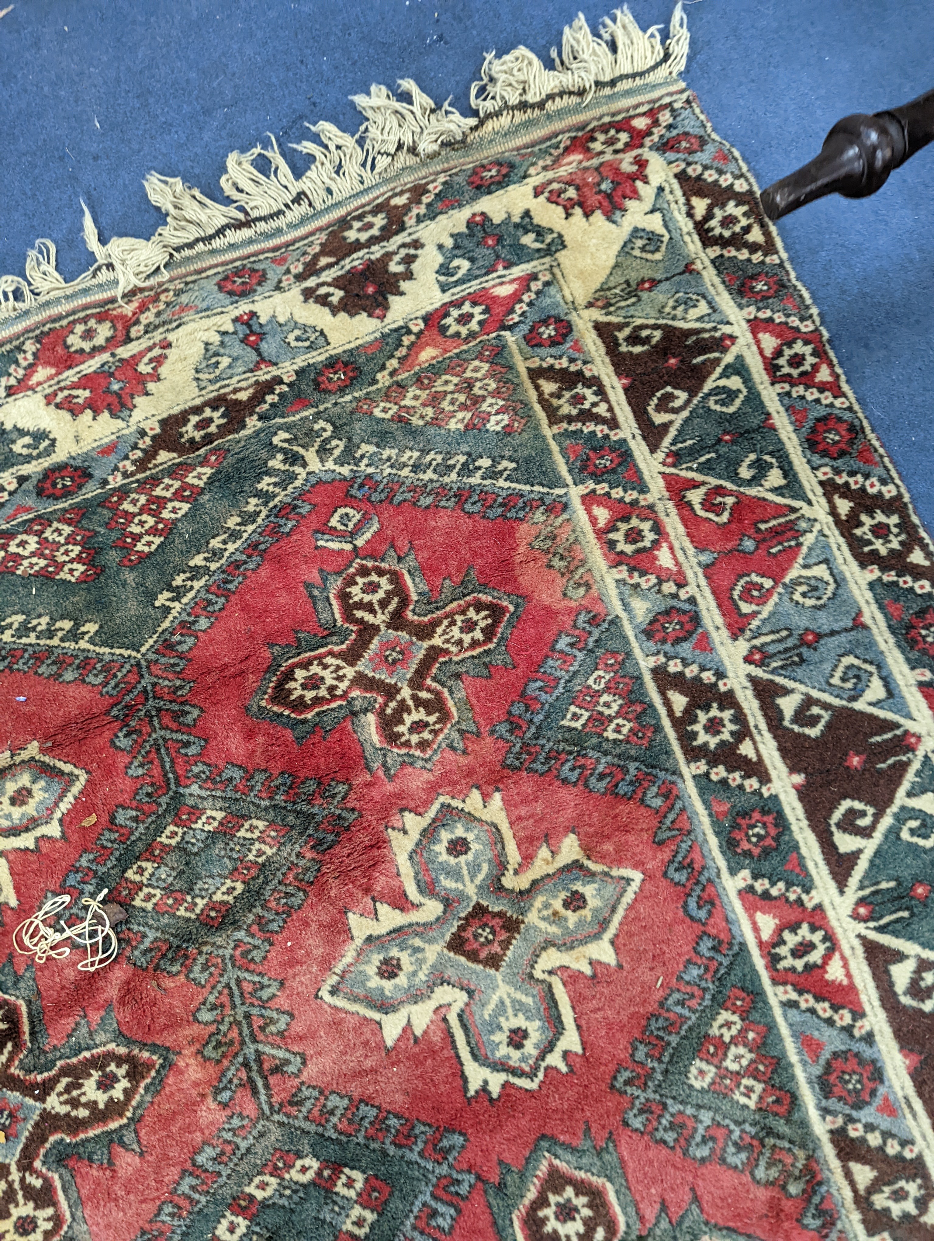 A Caucasian style red ground carpet, 286 x 210cm